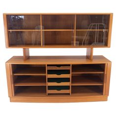 a wooden entertainment center with drawers and shelves