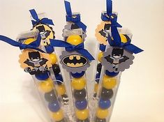 batman cake pops are in the shape of toothbrushes with yellow and blue decorations