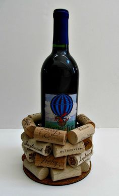 a bottle of wine sitting on top of a pile of wine corks in a holder