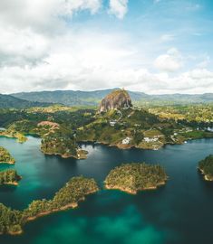 an aerial view of some small islands in the middle of water with trees around them