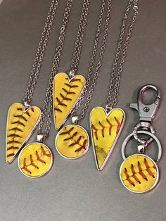 four softball heart shaped pendants on a chain