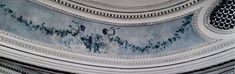 the ceiling is painted with blue and white designs