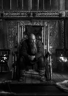 black and white photograph of an old man sitting on a throne