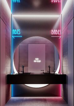 a bathroom with pink and blue lights on the wall, two sinks in front of a mirror