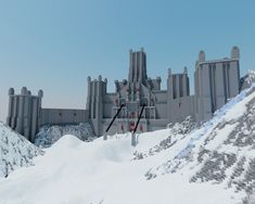 a very large castle sitting on top of a snow covered hill