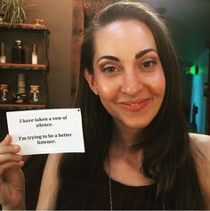 a woman holding up a sign that says i have taken a bow of science