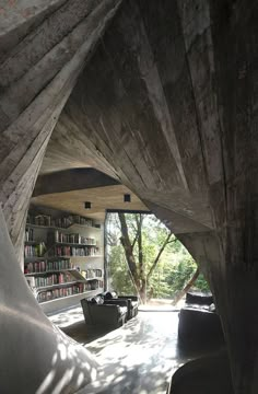 the inside of a house with bookshelves and couches