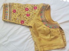 Custom fit pure raw silk blouse with Zardozi, Pearl & Kundan work embroidery on the sleeves. Piping on the sleeves edges and neck. Custom fitted. -Measurements sheet will be sent to you once you order( Standard sizing also available) -Custom colors available -Work on front back and sleeves. Please message me if you're have any specific requirements. This blouse can be done with or without the bust cup inserts . The blouse is fully lined is cotton. Usual turn around time is 1-2 weeks, but we Raw Silk Blouse, Mirror Work Blouse Design, Mirror Work Blouse, Pattu Saree Blouse Designs, Kundan Work, Maggam Work Blouses, Color Blouse, Hand Work Blouse, Multi Color Blouse