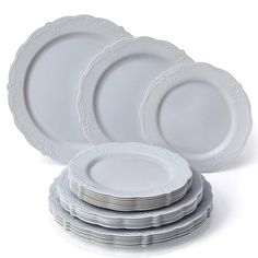 a stack of white plates sitting on top of each other