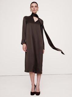 A modern, minimalist design, this midi dress is cut with a tie neck with extra long ties so you can wrap, drape or tie them as your imagination invites.  For fabric, we selected our signature silk charmeuse, a fabric we love for its beautiful drape, satin-like shine, and ease of care.  Trapeze Fit: Relaxed with an A-line shape - no waist definition.  Notch neck with tie detail.  Keyhole cutout at back.  Tall cuffs with single button.  Unlined.  Trapeze Fit: Relaxed with an A-line shape - no wais Office Chic, Modern Minimalist Design, Beautiful Drapes, Silk Charmeuse, Tie Neck, Well Dressed, Silk Ties, Extra Long, Modern Minimalist