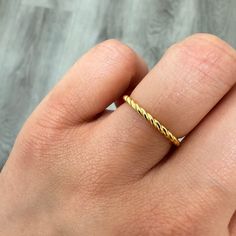 a woman's hand with a gold ring on it