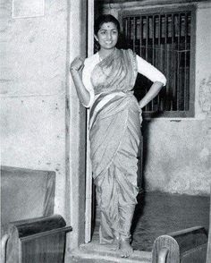 an old photo of a woman posing for the camera