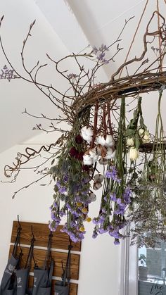 dried flowers hanging from the ceiling in a room