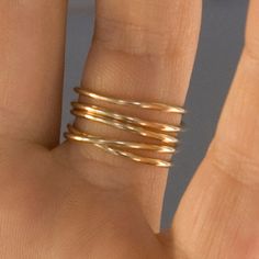 Unique, fun, lightweight. This Wrap Ring creates an eye catching illusion of 5 stacked rings that flow and criss-cross over one another. Made form 14k gold fill. If you would like an unlisted ring size, no problem! Just request your size in the order notes.  High shine or matte finish available. Simple Stackable 14k Gold Filled Rings, Modern Twist Stackable 14k Gold Midi Rings, Modern Twist 14k Gold Midi Rings For Everyday, Everyday Modern Twist 14k Gold Midi Rings, Modern Twist 14k Gold Midi Rings, Stacked Rings, Wrap Ring, Wrap Rings, Stacking Rings