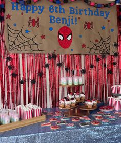 a birthday party with spiderman decorations and cupcakes