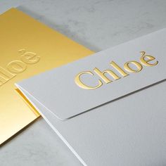 two gold and silver business cards with the word choice written on them, sitting next to each other