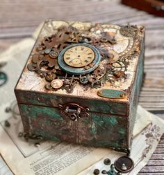 an old box with a clock on it sitting on top of a piece of paper