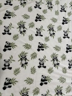 a panda bear print fabric with green leaves