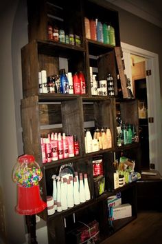 the shelves are filled with many different types of hair care products, including shampoos and lotions