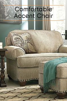 a living room scene with focus on the chair and footstool in the foreground