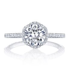 a round cut diamond ring with pave set shoulders