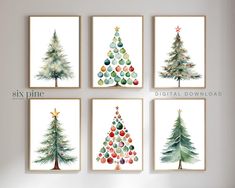 six watercolor christmas trees on white paper in different sizes and colors, hanging on the wall