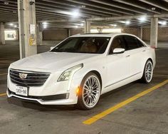 a white car parked in a parking garage