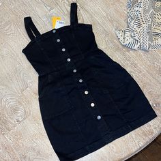 Questions? Leave A Comment Below! Black Sleeveless Denim Summer Dress, Sleeveless Black Denim Dress, Black Sleeveless Denim Dress, Trendy Cotton Dress With Button Closure, Black Mini Dresses With Pockets, Black Cotton Mini Dress For Spring, Black Buttoned Summer Denim Dress, Spring Black Cotton Mini Dress, Black Buttoned Denim Dress For Summer