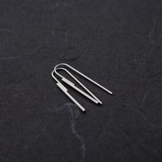 Elevate your style with these Handmade Sterling Silver Threader Earrings. Crafted with precision, these minimalist earrings feature two sterling silver wires--one at 1.5mm thickness soldered to another at 1mm. The sleek, modern design elegantly threads through your earlobe, creating a striking yet simple statement piece that measures 40mm in height. Choose between a subtle matte finish for a soft, understated look or a polished shiny finish for added brilliance. Whether you're dressing up for a Minimalist Hypoallergenic Threader Earrings For Everyday, Minimalist Dangle Threader Earrings For Everyday, Minimalist Linear Earrings As Gift, Minimalist Sterling Silver Linear Earrings, Minimalist White Gold Earrings For Pierced Ears, Minimalist Threader Drop Earrings For Everyday, Minimalist Everyday Threader Drop Earrings, Minimalist Everyday Drop Threader Earrings, Minimalist Sterling Silver Linear Earrings Nickel-free