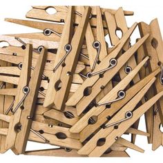 a pile of wooden clothes pegs with metal pins stuck in the top and bottom