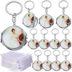 a set of eight key chains with pictures on them and one piece of cloth next to it