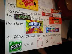 a bulletin board with candy bars on it and writing on the whiteboard next to it