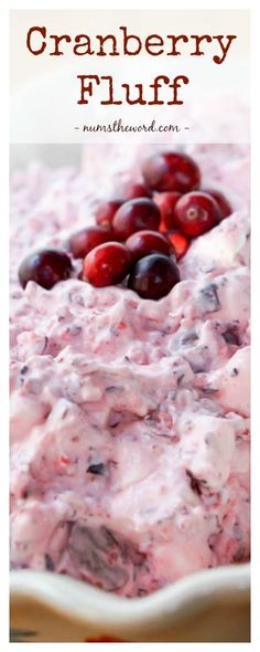 cranberry fluff in a white dish with cherries on top and the words above it