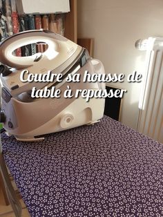 an iron sitting on top of a table next to a radiator