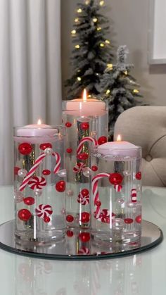 christmas floating candles with candy canes and candies in glass containers on a tray