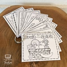 the fruit of the spirit coloring book is on top of a wooden table