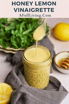 honey lemon vinaigrette being poured into a mason jar filled with fresh ingredients