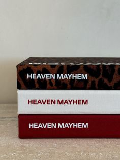 three books stacked on top of each other with the title heaven mayhem printed on them