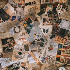 many different pictures and stamps are spread out on the floor