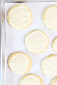 frosted cookies on a baking sheet with white icing