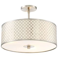 a light fixture with a circular design on the top and white fabric covering over it