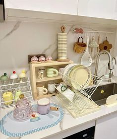 a kitchen counter with dishes and cups on it