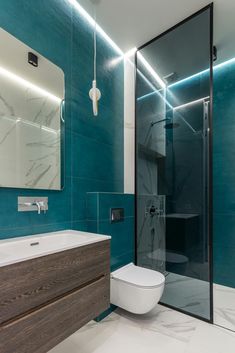 a bathroom with a toilet, sink and shower stall in it's center area