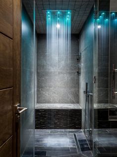 a walk in shower sitting next to a wooden door