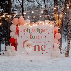 a sign that says oh what fun it is to be one with balloons around it