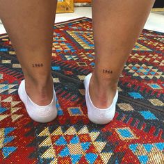 a woman's legs with small tattoos on her left leg and the number 2013 tattooed on her right ankle