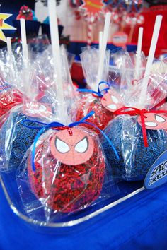 spiderman candies are wrapped in plastic and tied with red, white and blue sprinkles