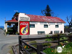 an old building with a coca - cola sign in front of it