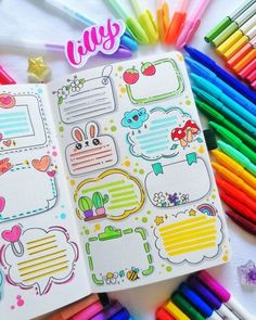 an open notebook with stickers on it next to colored pencils and markers in the background