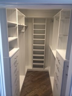 an empty walk in closet with shelves and drawers